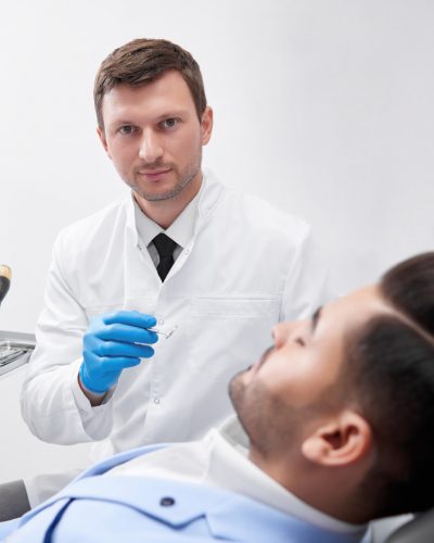 young-man-visiting-dentist-BEUGEF6.jpg