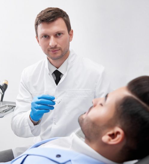 young-man-visiting-dentist-BEUGEF6.jpg
